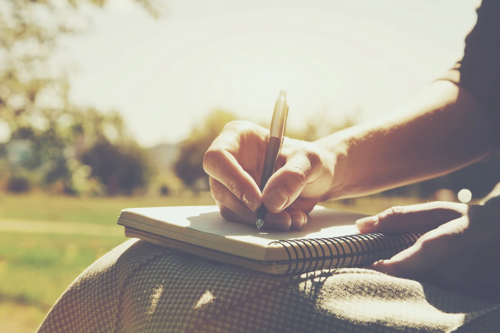 man write in notebook